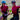 two women matching shirts smiling on bikes outside